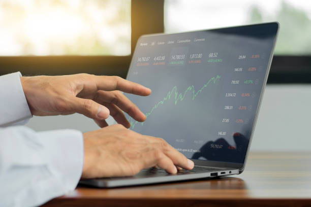 istock Businessman monitor digital graph chart trade online on computer, Trading online 1332802435