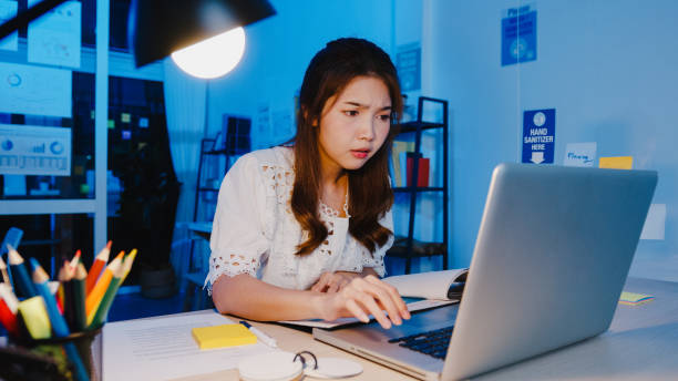 istock Freelance Asia women using laptop hard work at new normal home office. 1332802516