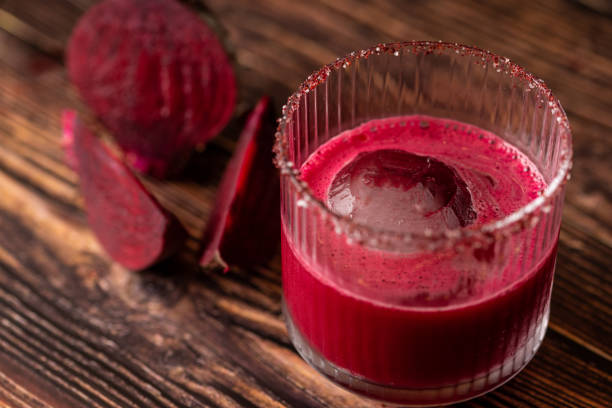 istock Alcoholic beetroot cocktail beverage in elegant glass on wooden table. 1332802690