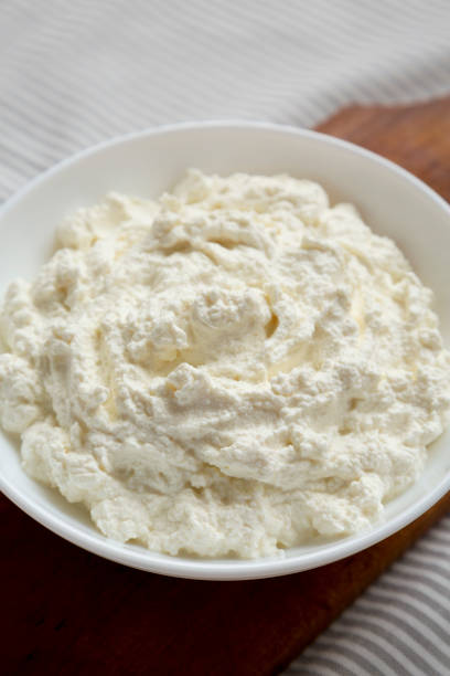 istock Tasty Ricotta Cheese in a White Bowl, low angle view. Close-up. 1332803587