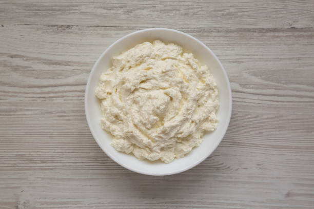 istock Tasty Ricotta Cheese in a white bowl, top view. Overhead, from above, flat lay. 1332803697