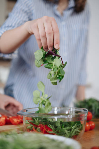 istock Woman hands cooking a salad 1332804683
