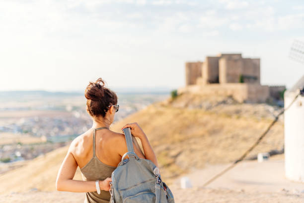 istock Woman in a hill with a medieval castle 1332804751