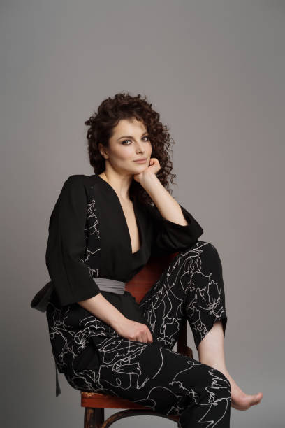 istock Curly woman portrait on gray background 1332805757