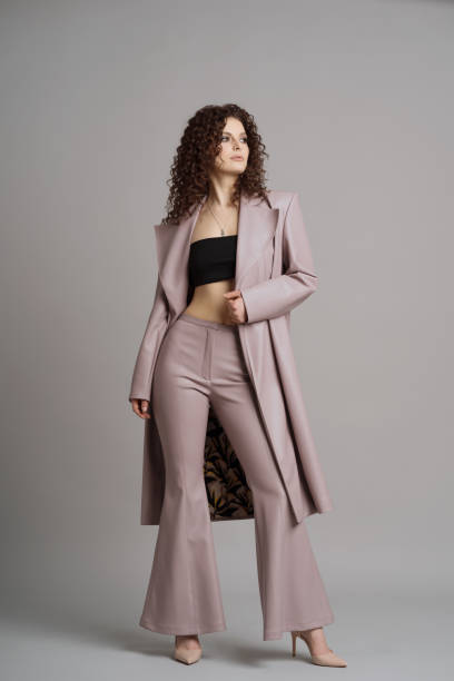 istock Woman in leather stylish clothes on studio gray background 1332805814