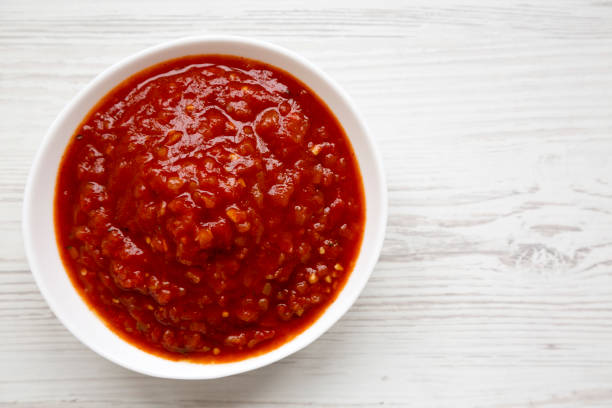 istock Homemade Tomato Salsa on a white wooden surface, top view. Flat lay, overhead, from above. Copy space. 1332805907