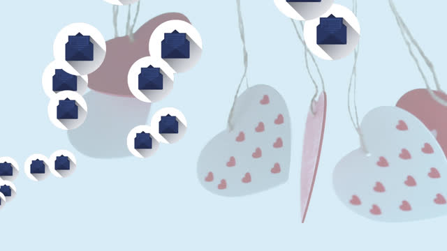 Multiple message icons floating over hanging heart shape decorations against white background
