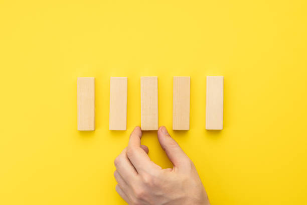 istock blank wooden blocks stack over yellow background. business strategy template. step notes mockup. above view 1332810709