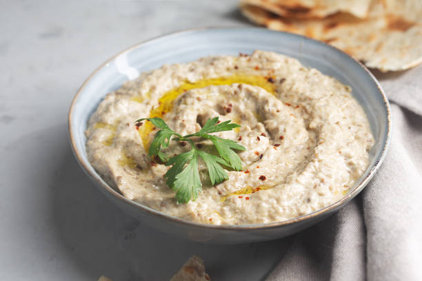 istock Baba ganoush, Ezme in a plate with pita bread on a concrete background 1332810821