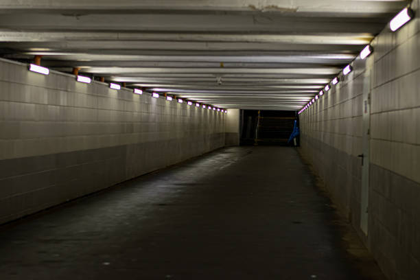 istock underground passage with lanterns. A long concrete tunnel with lanterns in the city underground. 1332813577