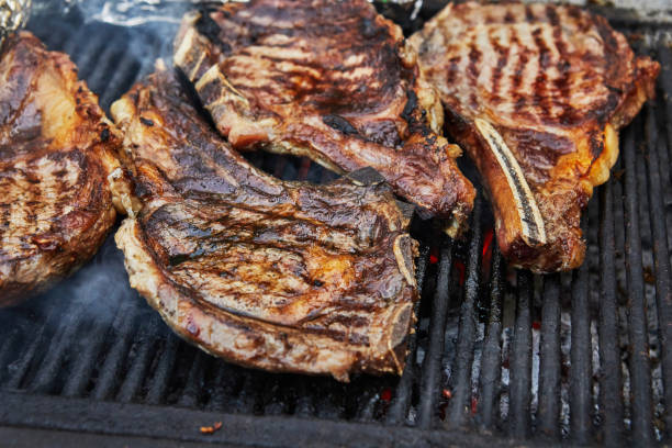 istock Grilled beef steaks with grill smoke. BBQ party 1332813826