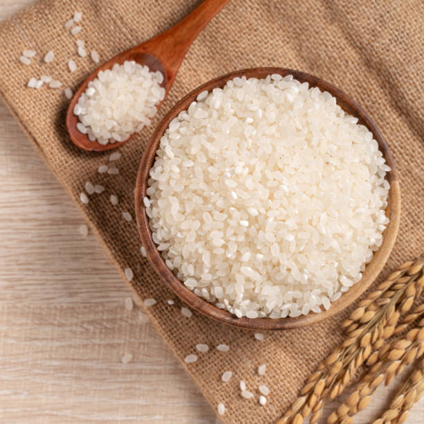 istock White rice in a bowl on wooden table background. 1332817102