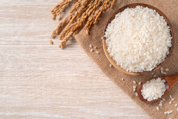 istock White rice in a bowl on wooden table background. 1332817112
