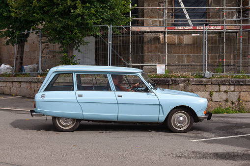 Pleyber-Christ, France - July 04 2021: Couple driving their Citroën Ami 8 station wagon.