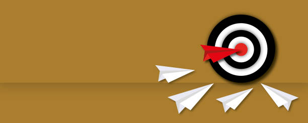 istock Red paper plane with white paper planes hitting in the target on a brown background as metaphor for business target. 1332822305