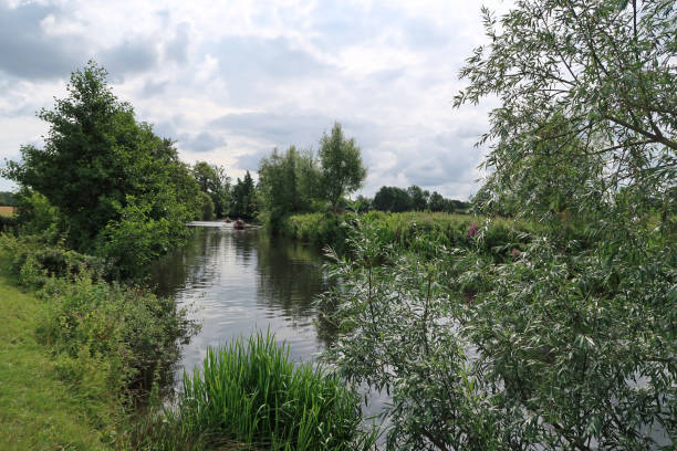 istock River Stour on a summers day outdoors. Distant rowing boats, near Flatford Mill 1332823870