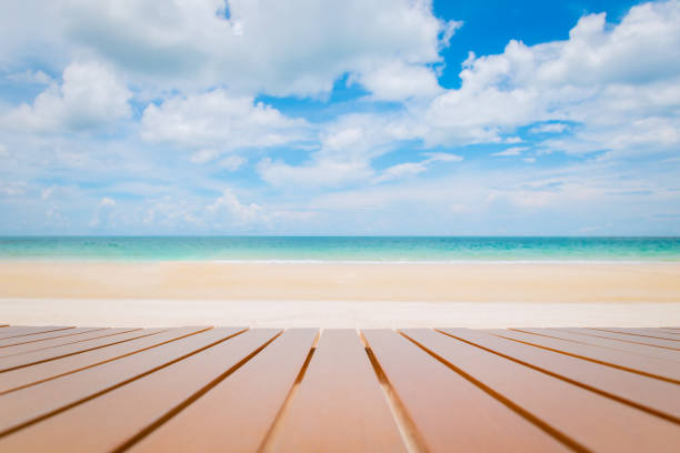 istock Wooden table on tropical beach. 1332823929