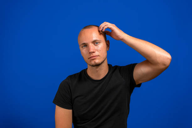 istock Young caucasian doubtful man thinking, scratching head and trying to find solution, isolated on blue background. Doubt concept 1332825270