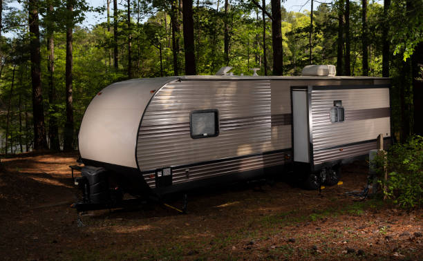 istock Camper trailer at a campsite seen from the water hookup side 1332828432