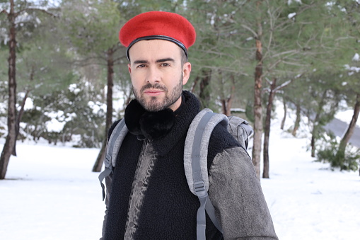 Man wearing red beret in the snow.