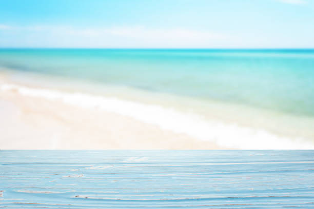 istock Blue wood table top on blur sea background 1332831459