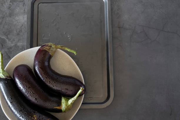 istock Raw purple aubergine on dark background 1332832903