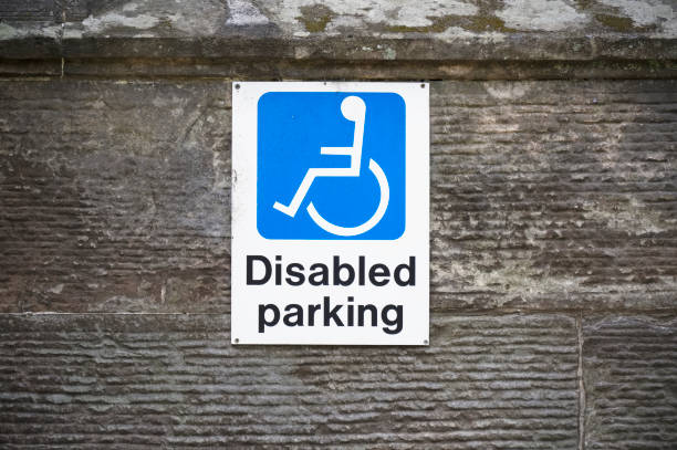 istock Disabled blue badge holder parking sign for driver 1332833903