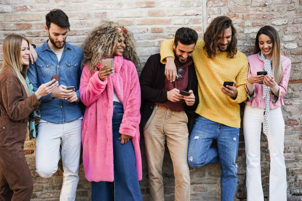 istock Young happy people having fun together with mobile phone app - Focus on faces 1332835934