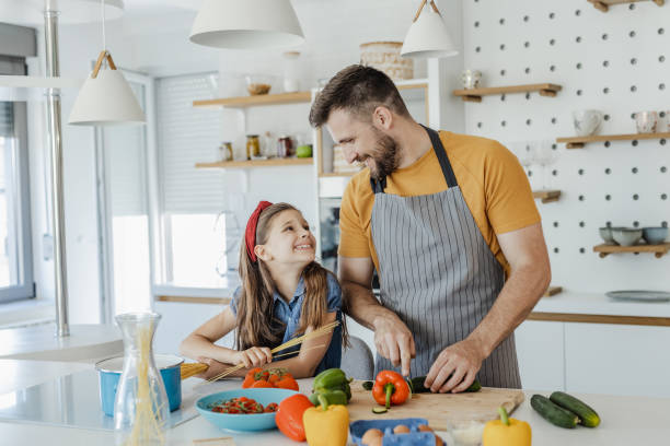 istock Having fun while preparing healthy meal with father in the kitchen 1332837668