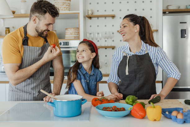 istock Having fun while preparing healthy meal with mother and father in the kitchen 1332837674