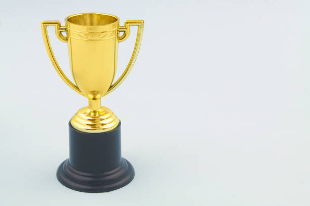 istock Champion golden trophy cup on blue background 1332839188