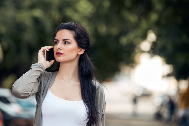 istock Young cute female using smartphone on the street. 1332842489