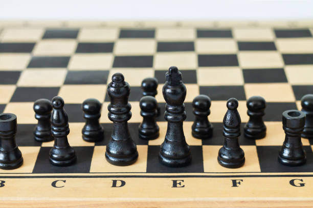 istock Black chess pieces or figures on game chessboard 1332843125