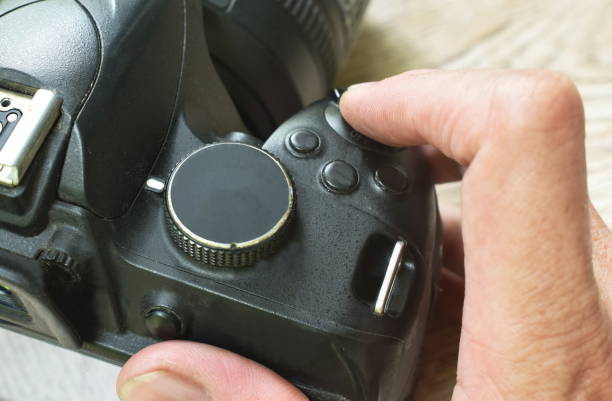 istock finger pushing shutter button of digital single lens reflect camera 1332843162