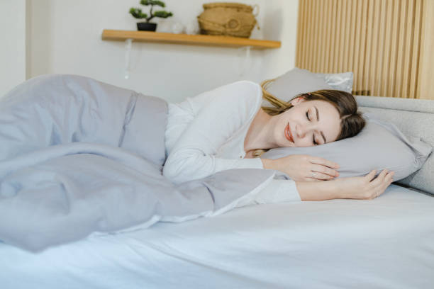 istock Young woman is sleeping in bed at home 1332847393