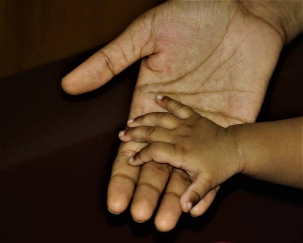 istock Littly baby hand  touching her mother's hand 1332852025