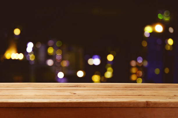 istock Empty wooden table over abstract blurred restaurant lights background.  Mock up for design and product display. 1332852086