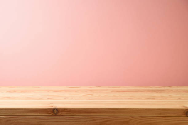 istock Empty wooden table over pink wall background.  Interior mock up for design and product display. 1332852102