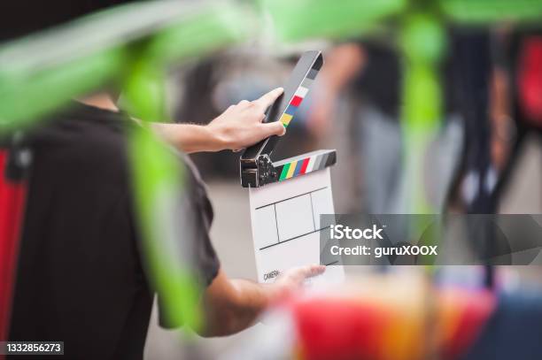 Man Holding A Clapperboard In Front Of The Camera Stock Photo - Download Image Now - Film Set, Filming, Movie