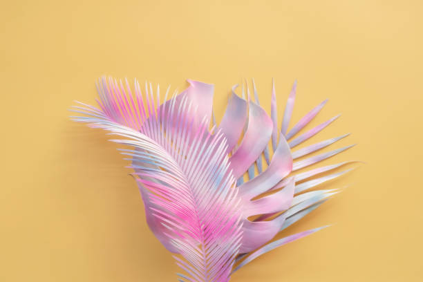 istock Palm leaves and monsters on a yellow pastel background exotic tropical forest summer background pastel art colorful minimalist style 1332857581