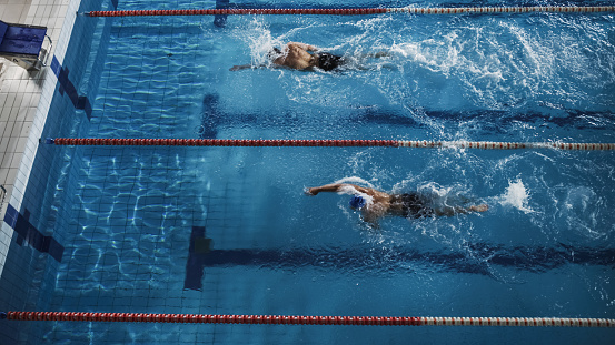 Visual symphony as a synchronized swimmer duet leaps into their performance