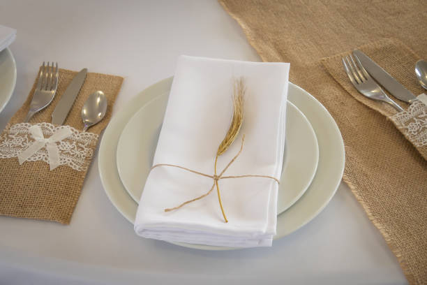 istock prepared table with plates and folded napkin 1332860636