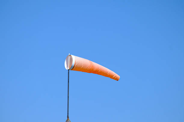 istock orange wind sock flying in the wind to show wind direction 1332861831
