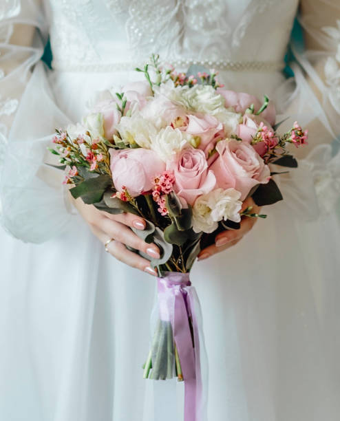 istock woman with bridal bouquet. eremony wedding day. hands with wedding rings. 1332863993