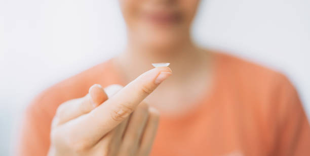 istock Young girl holding lens for vision on her finger 1332864962