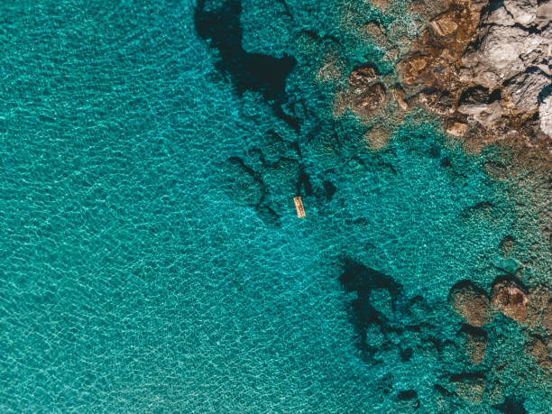 Aerial view of woman enjoying in the water,Ionian Islands, Greece Beautiful young woman enjoying swimming in clear turquoise sea greek islands stock pictures, royalty-free photos & images