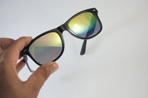 istock Close-up of hands holding rainbow glasses 1332867745