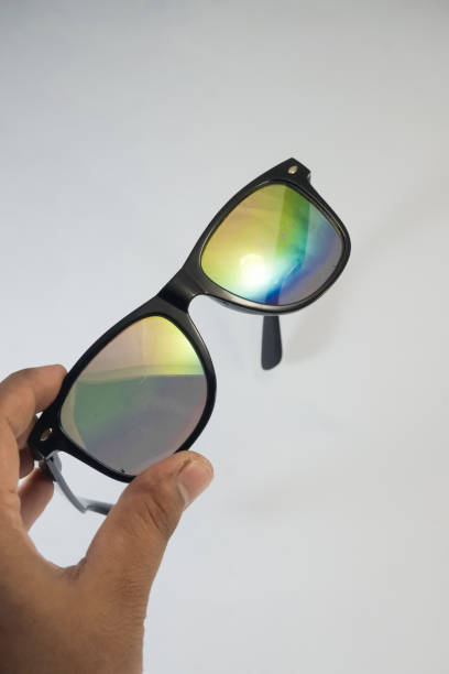 istock Close-up of hands holding rainbow glasses 1332867775