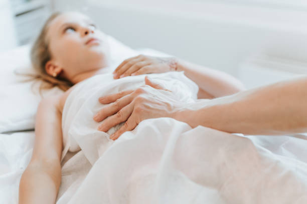 istock real doctor osteopath hands does physiological and emotional therapy for eight year old kid girl. pediatric osteopathy treatment session. alternative medicine. taking care of the child's health 1332874814