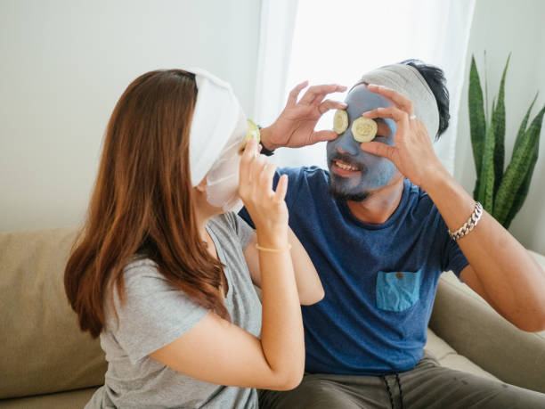istock Happy couple doing facial mask. 1332876252